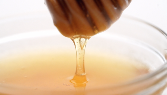Honey dripping from a honey spoon