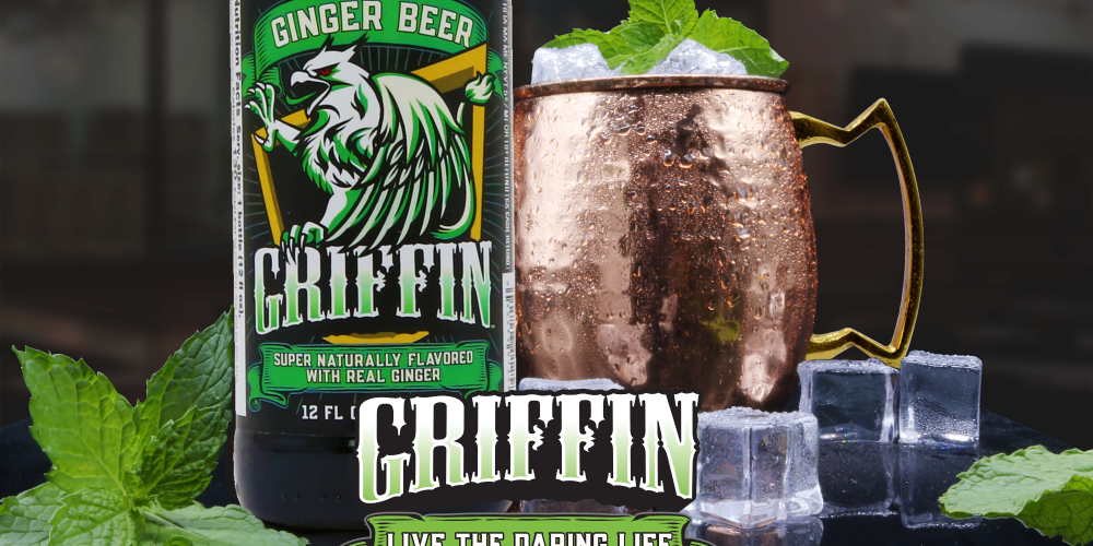 A bottle of Griffin Ginger Beer next to a copper mug with ice and mint