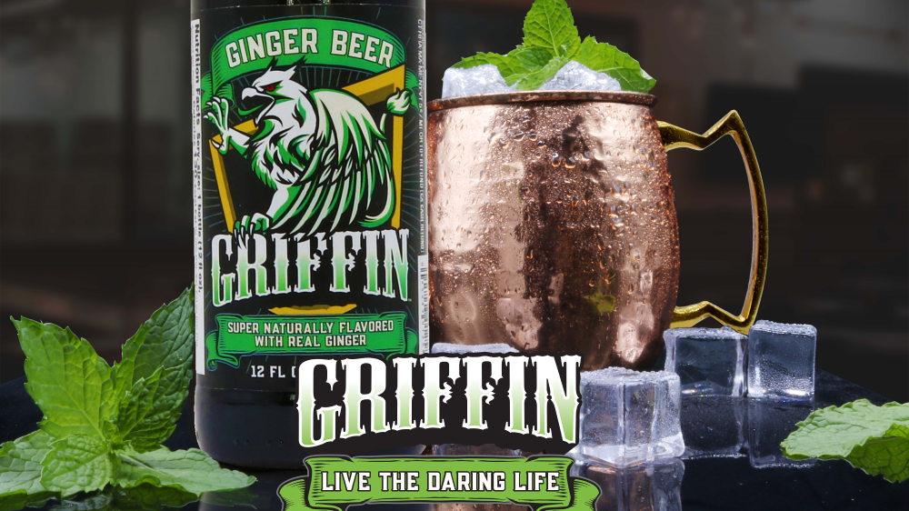 A bottle of Griffin Ginger Beer next to a copper mug with ice and mint
