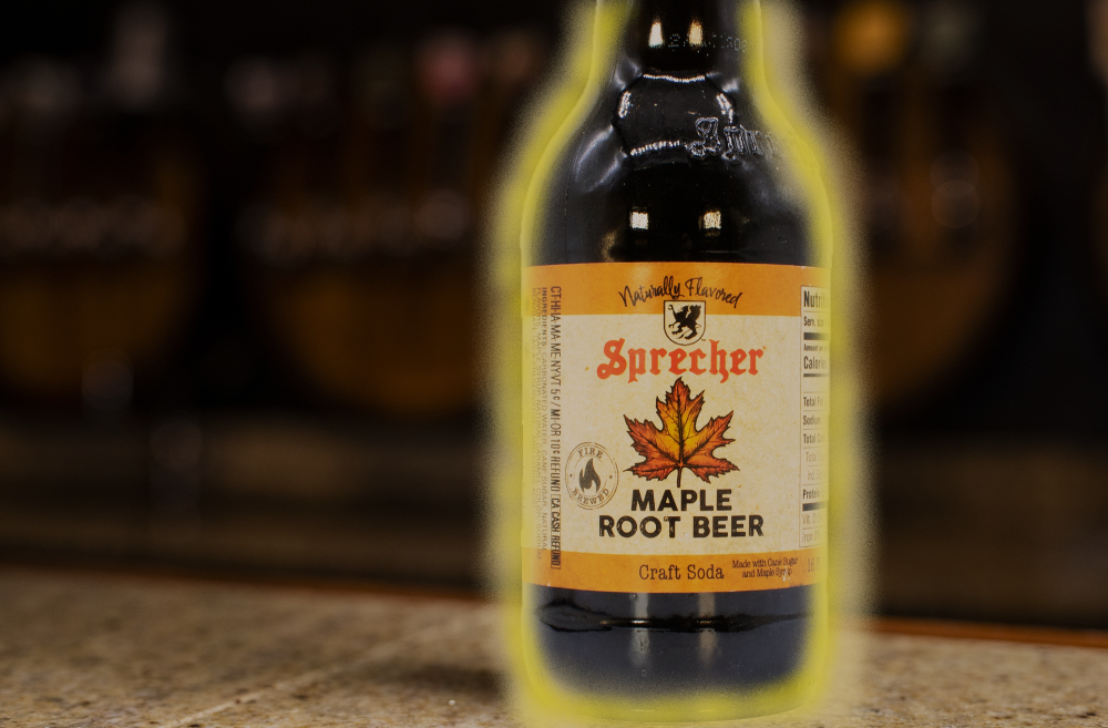 glowing maple root beer bottle on a bar