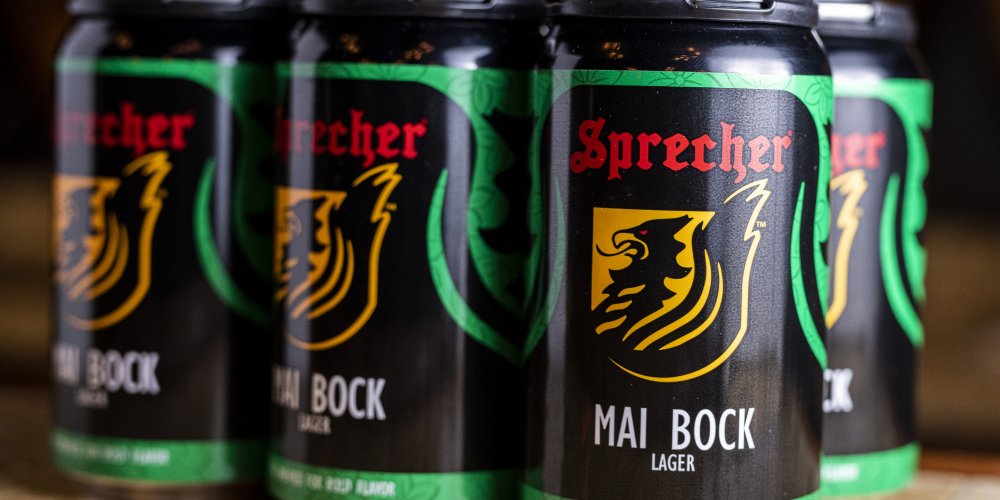 A closeup of a 6 pack of sprecher mai bock cans