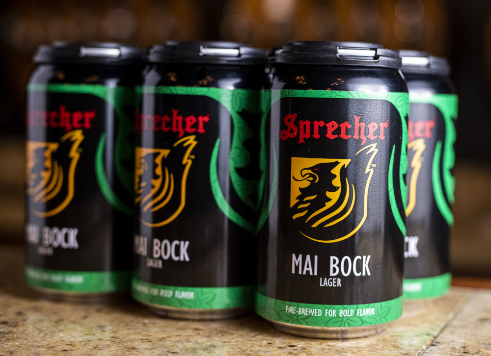A closeup of a 6 pack of sprecher mai bock cans