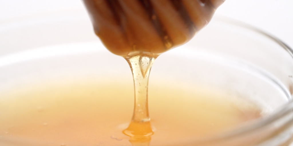 Honey dripping from a honey spoon