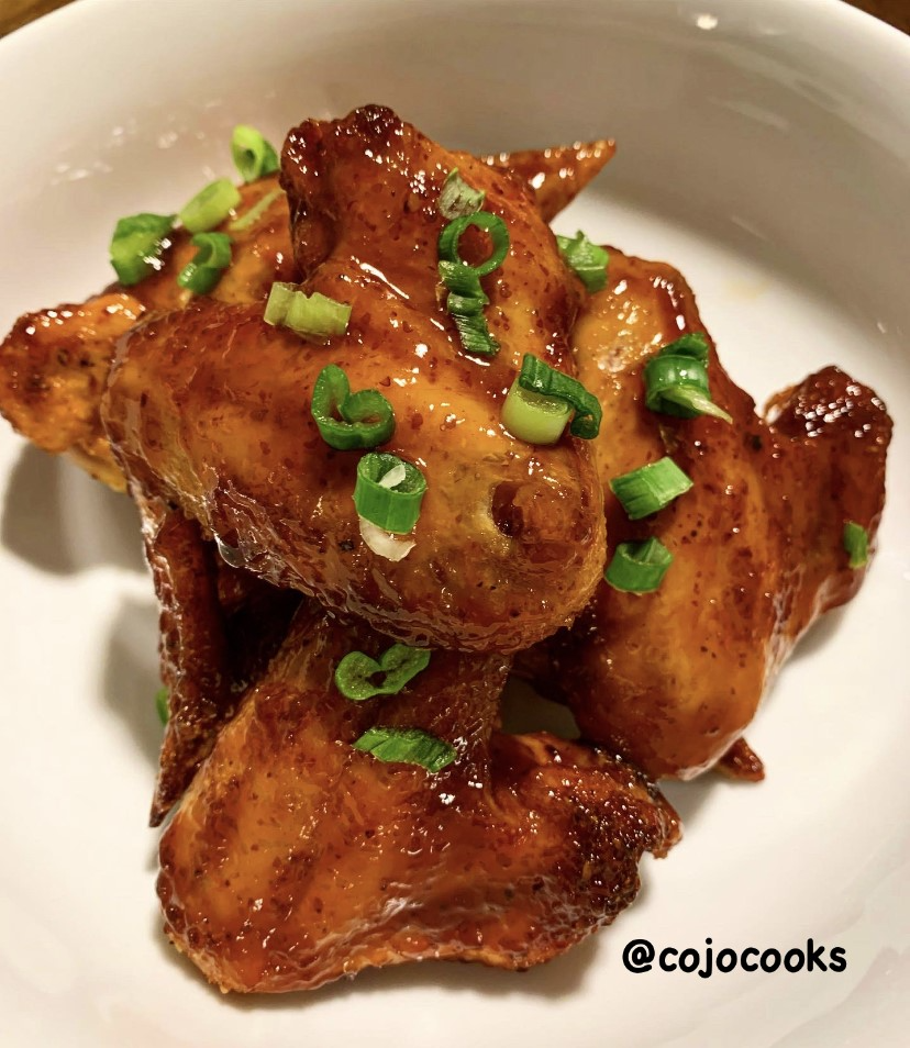 Sprecher Root Beer Glazed Wings with chopped green onions on a plate