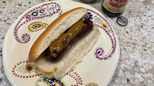 A maple root beer brat on a plate