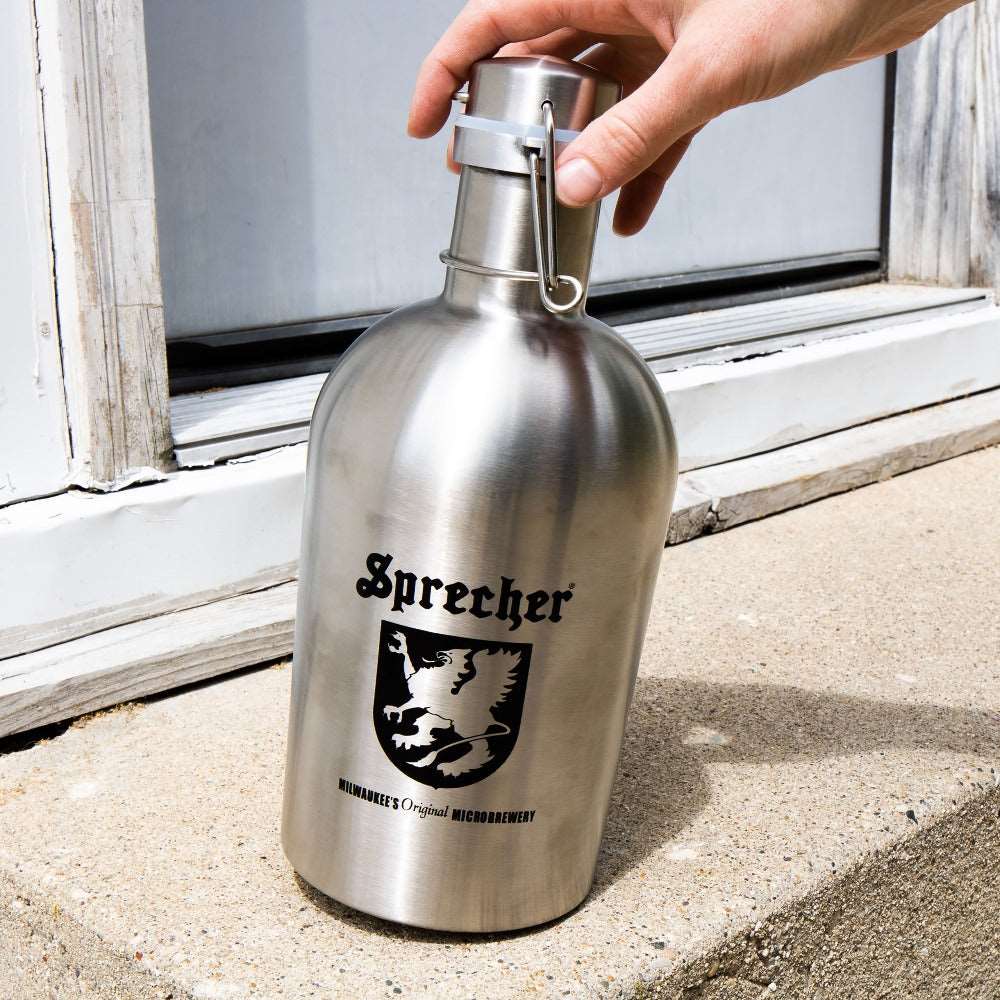 Someone picking up a Sprecher Stainless Steel Growler from the top
