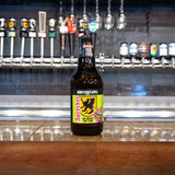 Honeycrisp apple soda bottle on a bar counter with beer taps in the background