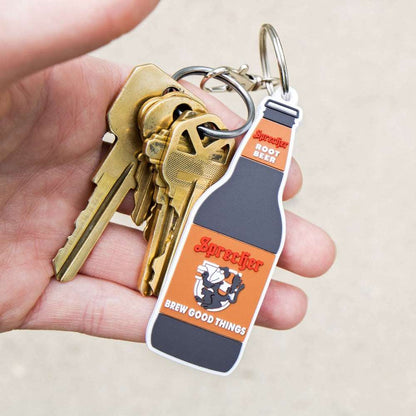 Someone holding a Sprecher Root Beer Keychain in their hand