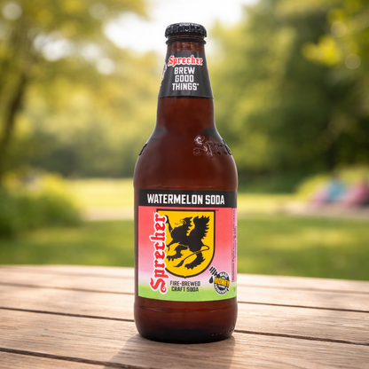 Sprecher watermelon soda bottle on a wooden surface with a blurred green outdoor background
