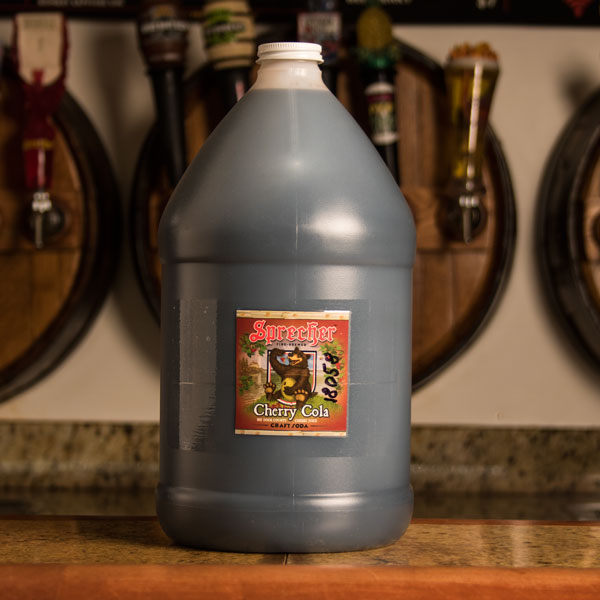 A gallon jug of Sprecher Cherry Cola Extract on bar