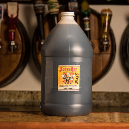 A gallon jug of Sprecher Cream Soda Extract on a bar