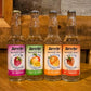 12oz bottles of Sprecher Red Raspberry, Fresh Cut Mango, Valencia Orange, and Ripe Strawberry Sparkling Waters.